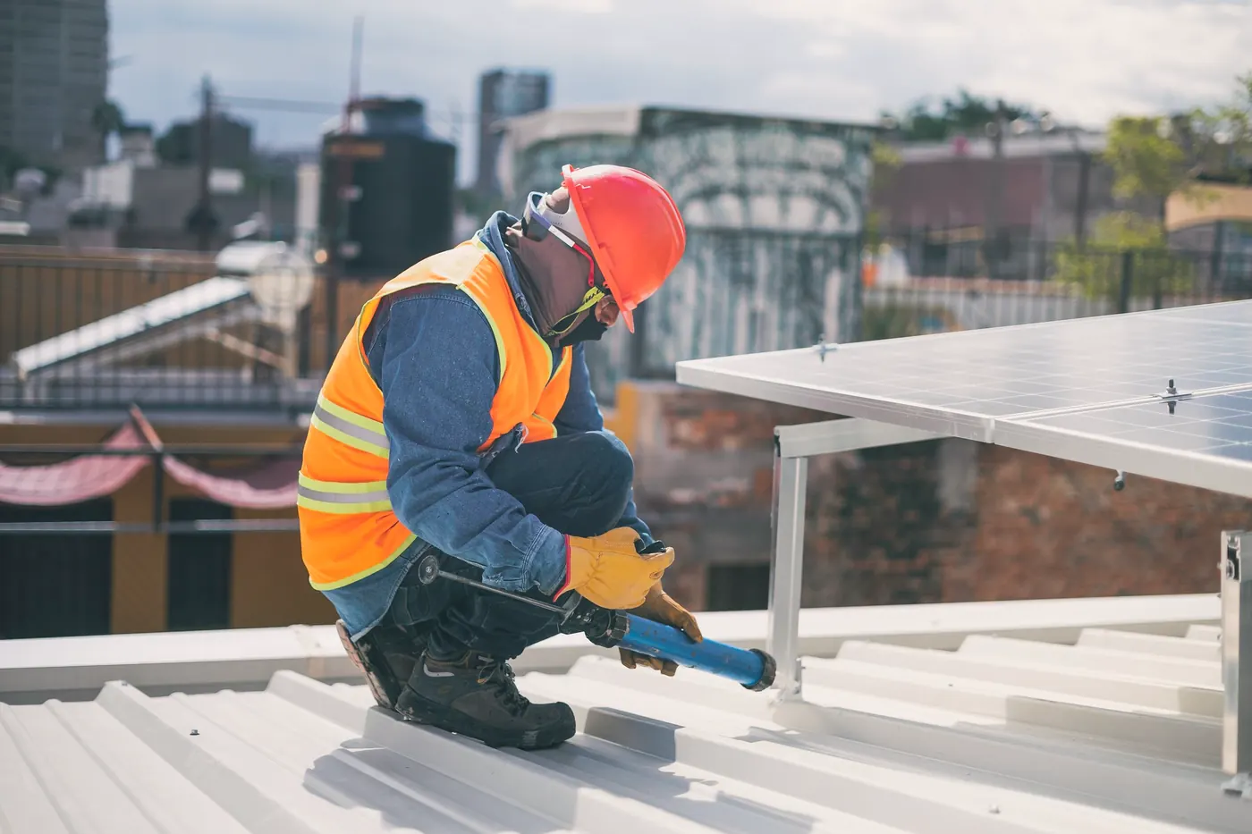 Installer fitting solar mounting rails on a commercial metal roof